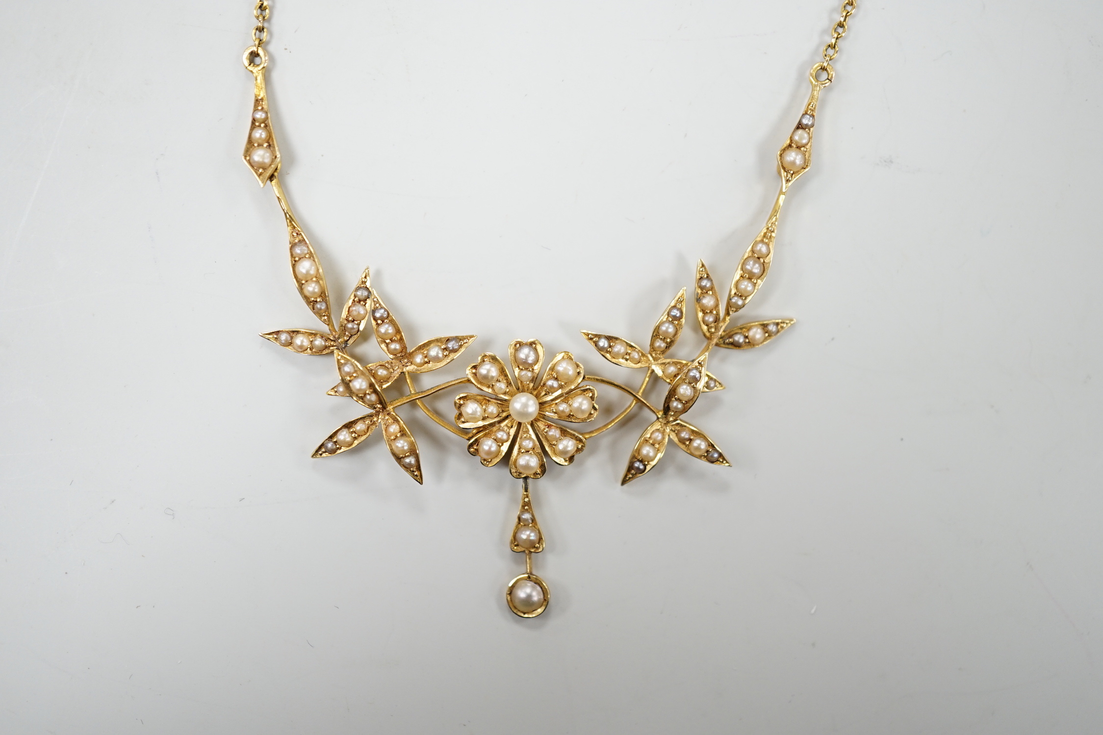 An Edwardian 15ct and seed pearl set drop necklace, 44.5cm, gross weight 8.6 grams.